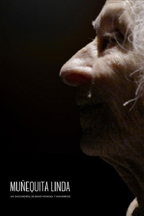 Close-up of an elderly woman's face in profile, in the dark, with a smile on her lips.